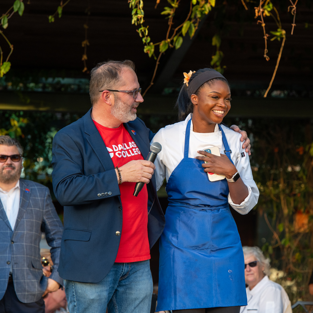 2026 Bits and Bites Honoree, Steve DeShazo, with a culinary student speaking at event