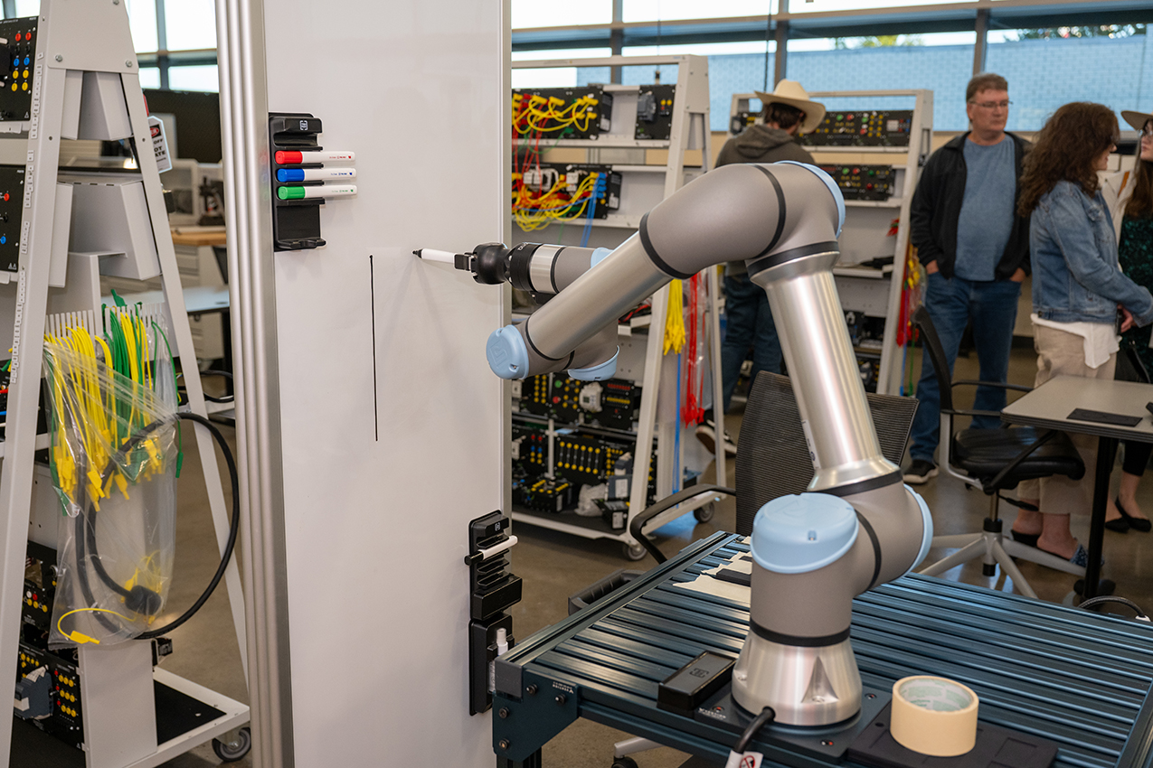 Robotic arm writing on dry erase board on Dallas College campus